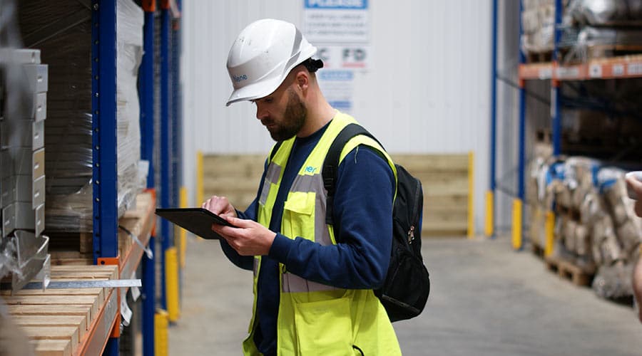 CEAF TECH inspector examining a warehouse storage rack in Lahore.